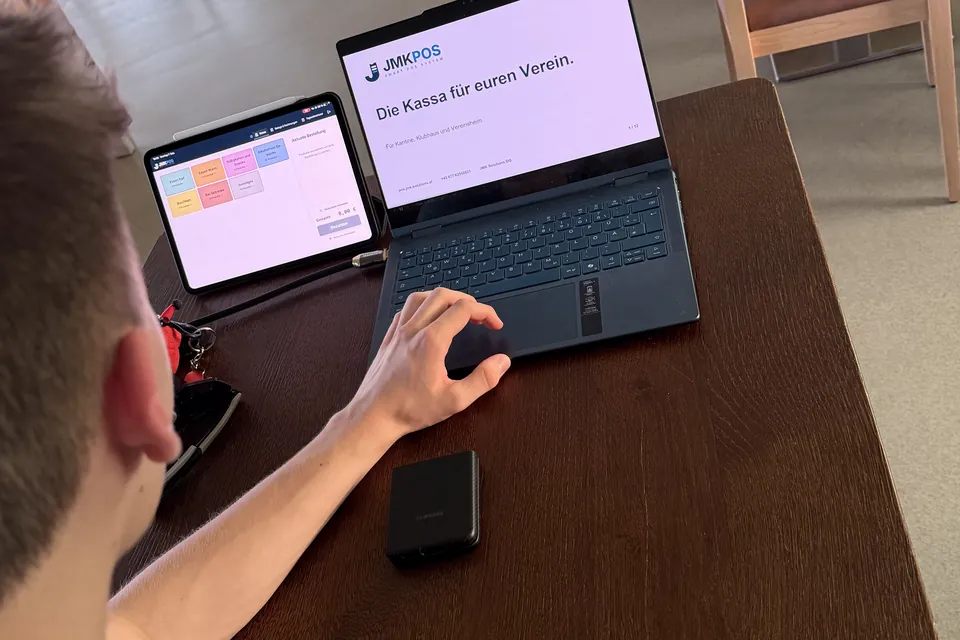 JmkPOS-Kassenansicht auf einem Tablet, daneben der Laptop mit der Präsentation.